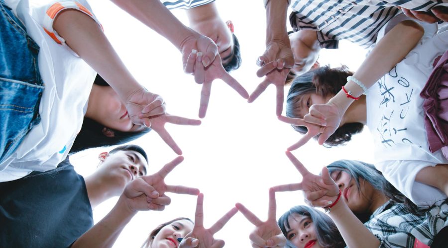 Group of People Forming Star Using Their Hands