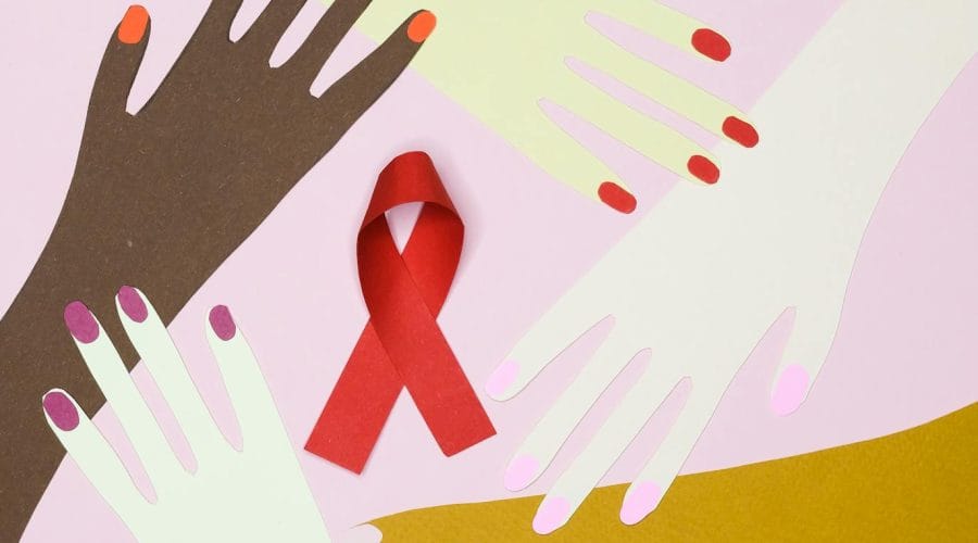 Illustration of diverse hands surrounding a red awareness ribbon symbolizing unity and health awareness.
