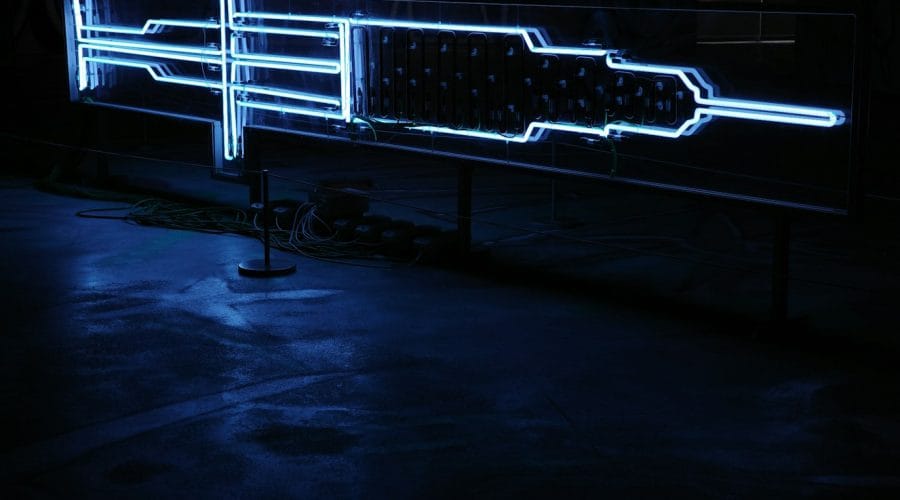 a neon sign in the middle of a dark room