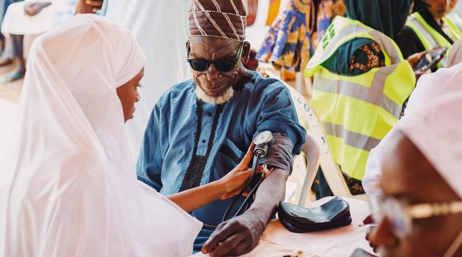 Elderly man receives medical care during community health outreach in Kaduna, Nigeria.