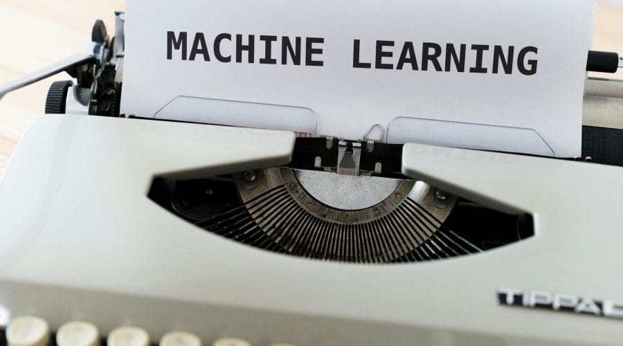 a close up of a typewriter with a paper reading machine learning