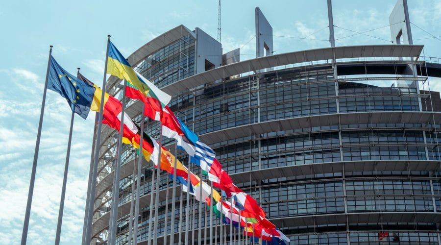a large building with a lot of flags in front of it