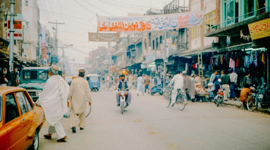 A group of people riding bikes down a street